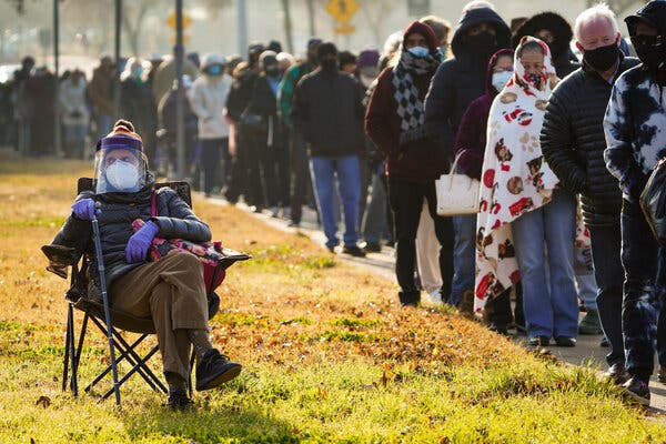 Florence Mullins, 89, sitting to wait as a family member held her place in a long line to receive a coronavirus vaccine at Fair Park in Dallas last month.