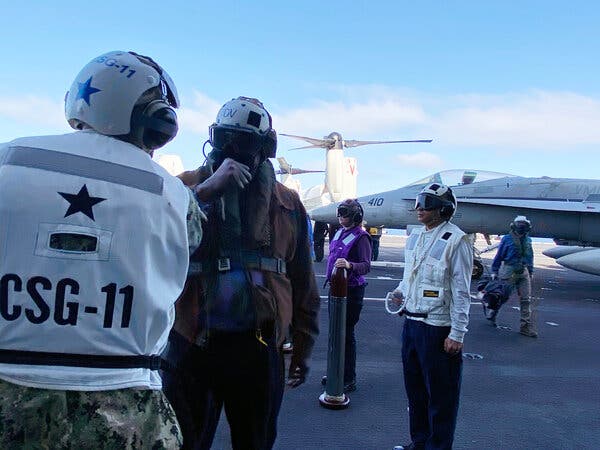 Defense Secretary Lloyd J. Austin III greeting troops aboard the carrier Nimitz on Thursday.