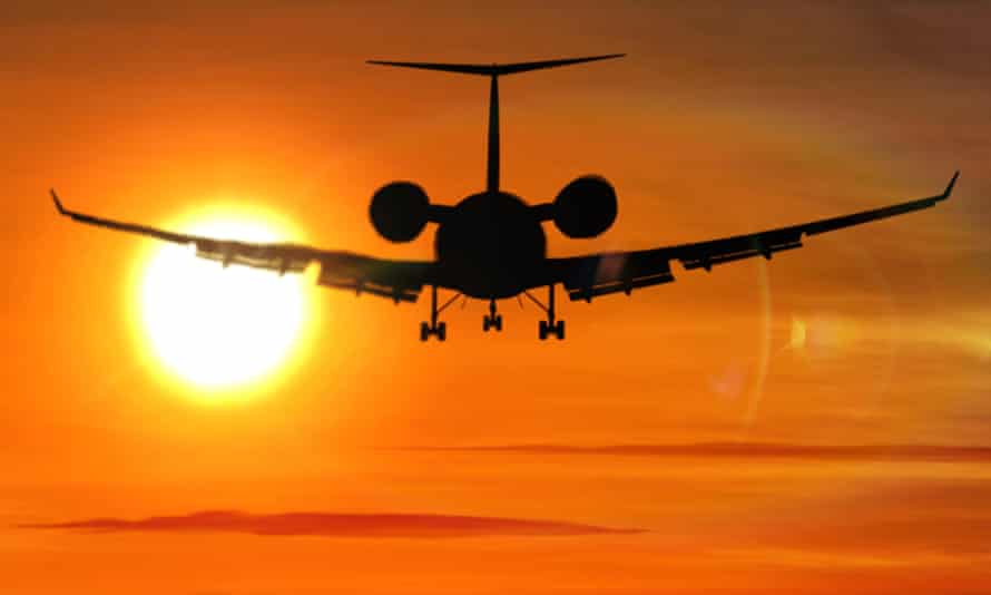 Airplane silhouette during sunset.