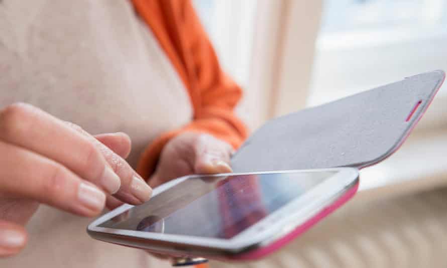 A woman touching a smartphone.