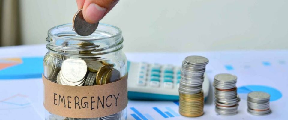 Person dropping coin into full jar that says 