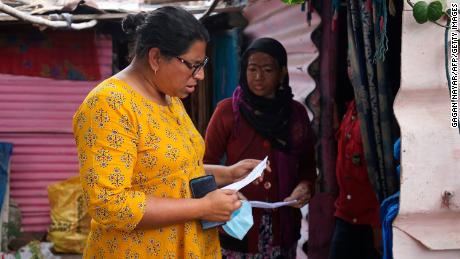 Activist Rachna Dhingra talks to a resident of Oriya Basti slum in Bhopal on January 8, 2021.