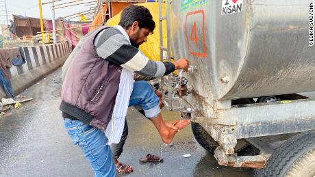 A farmer at the Ghazipur protest camp washes his leg, on February 4, 2021.