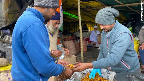 A farmer gives out food at the camp in Ghazipur, on February 4, 2021.