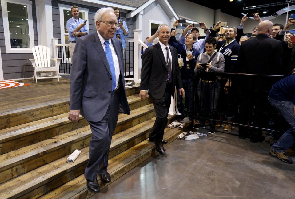 Berkshire Hathaway CEO Warren Buffett (L) walks with Kevin T. Clayton, CEO of Berkshire Hathaway subsidiary Clayton Homes, out of one of the company&#39;s houses prior to the Berkshire annual meeting in Omaha, Nebraska May 2, 2015.  Billionaire investor Buffett on Saturday defended his Clayton Homes unit against accusations that the manufactured home seller had preyed on lower-income purchasers with its lending practices. REUTERS/Rick Wilking