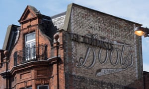 Faded wall sign for Boots the Chemist on Camden High Street, London.