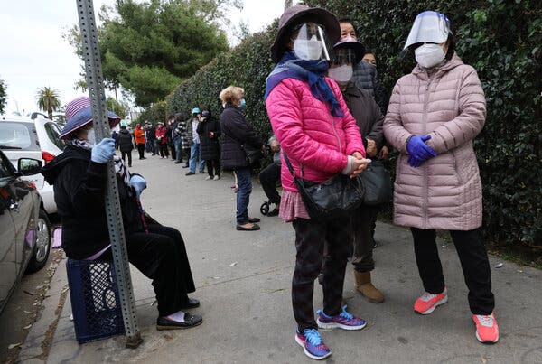 People waited in line Sunday with the hope of receiving leftover Covid-19 vaccine doses that would otherwise expire and be tossed out each day at the Kedren Community Health Center on in Los Angeles.