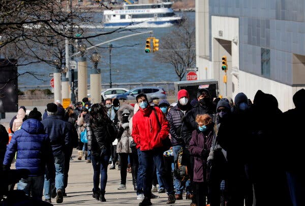 People waiting in a line this week stretching around the Jacob K. Javits Convention Center on Midtown Manhattan’s west side, to receive a coronavirus vaccine at the site which has been converted into a mass vaccination center in New York City.