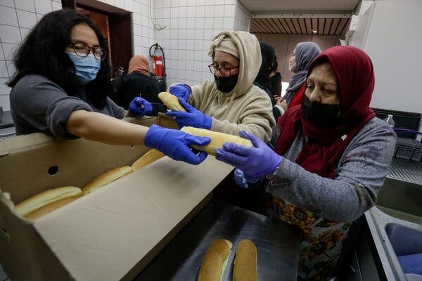 Volunteers from the Colis du Coeur Zakaria association hand out food to people in the working-class district of Marolles, in Brussels, in February, thanks to donations from individuals.