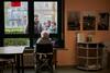 During the pandemic, nursing home residents, such as this woman in Cremona, Italy, in late February, have only been able to see relatives through a window. (Chiara Goia for The Washington Post)