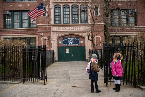 Students waiting to be admitted to PS 189 Bilingual Elementary School in Brooklyn last December.