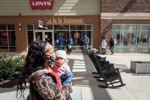 Shoppers wait in line at an outlet mall in Southaven, Miss. on Saturday. Many Americans are set to benefit from the new economic relief plan.