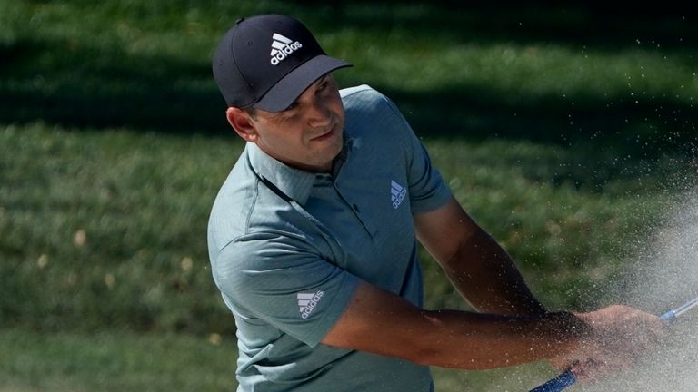 Garcia splashes out of a bunker at the ninth