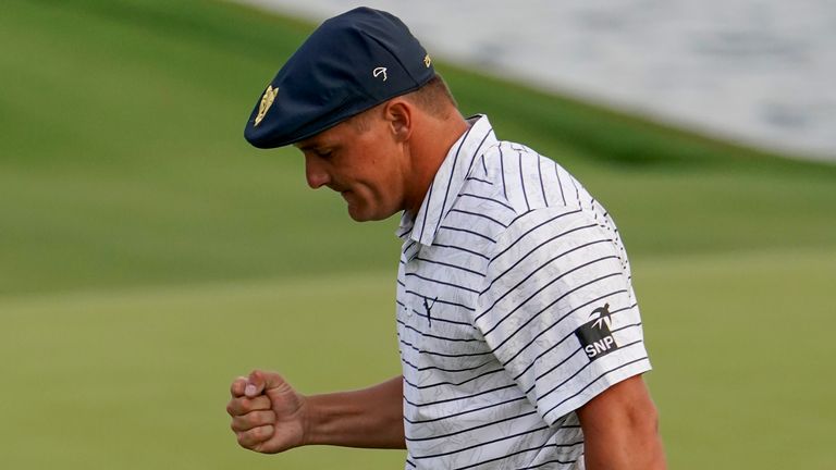 DeChambeau reacts after holing a crucial putt for par from 15 feet at the 18th at TPC Sawgrass on Saturday