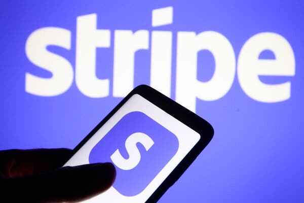 A photo illustration of a Stripe logo on a smartphone.