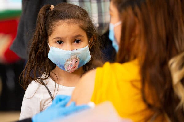 Brittany Siguenza, 5, watching her mother receive a Moderna vaccine dose in Massachusetts on Friday.