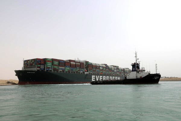 The Ever Given, stuck in the side of the Suez Canal. This is a handout photo made available by the Suez Canal Authority.