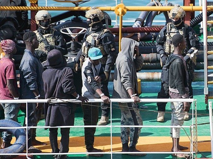 Migrants and security personnel onboard the El Hiblu 1.