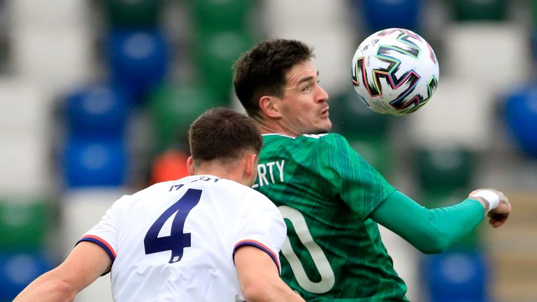 Northern Ireland&#39;s Kyle Lafferty jumps for the ball with Matthew Miazga 