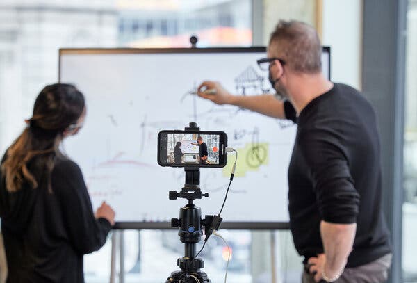 A mobile touch screen doubles as a digital whiteboard while a cellphone on a tripod makes a recording that can be used later in a presentation.