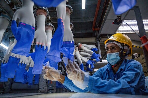 A worker inspecting disposable gloves at a Top Glove factory near Kuala Lumpur, Malaysia, in August.