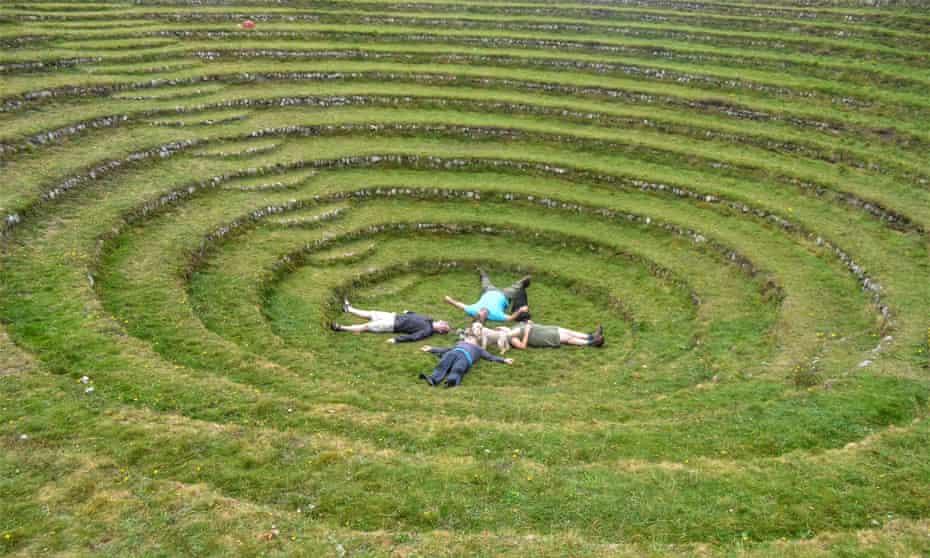 People lying on the grass of Gwennap Pit, Cornwall.