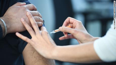 A pharmacist  administers an AstraZeneca Covid-19 vaccine injection at the Black Country Living Museum in Dudley, central England, on January 25, 2021.