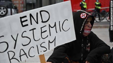 Protesters gather during a demonstration in central Montreal on October 3, 2020, to demand action for the death of Joyce Echaquan, a Canadian indigenous woman subjected to live-streamed racist slurs by hospital staff before her death.