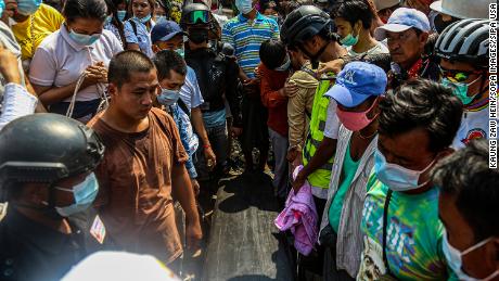 People stand next to Ma Kyal Sin&#39;s coffin during her funeral ceremony.