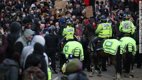 Police horses are deployed during the clashes, which began as a protest against a controversial crime bill.