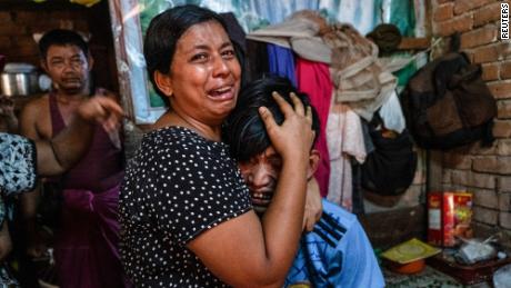 Family members cry in front of a man after he was shot dead during a crackdown on anti-coup protesters in Yangon, Myanmar, on Saturday.