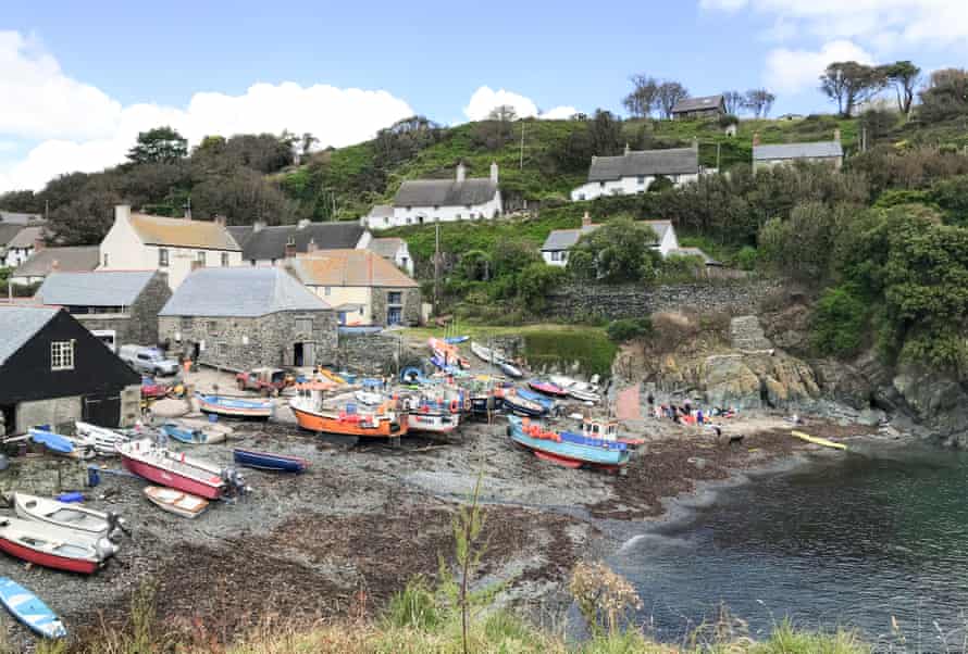 View of Cadgwith village, with cottages and fishing boats at the shore, Cornwall, UK.