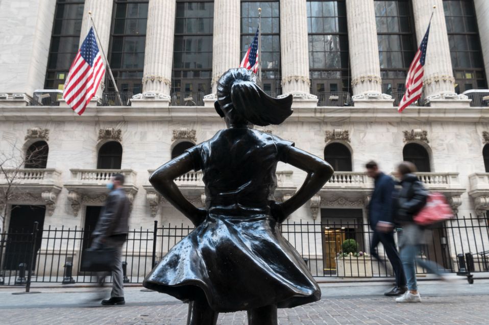 People walk past the New York Stock Exchange (NYSE) at Wall Street and the  &#39;Fearless Girl&#39; statue on March 23, 2021 in New York City. - Wall Street stocks were under pressure early ahead of congressional testimony from Federal Reserve Chief Jerome Powell as US Treasury bond yields continued to retreat. (Photo by Angela Weiss / AFP) (Photo by ANGELA WEISS/AFP via Getty Images)