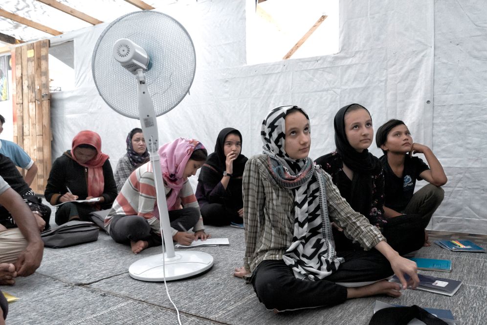 Refugee women learning English in the camp's school