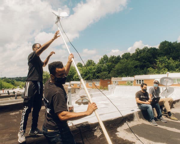 Adam Bouhmad, second from right, has helped low-income families in Baltimore get affordable internet service through his Waves project.