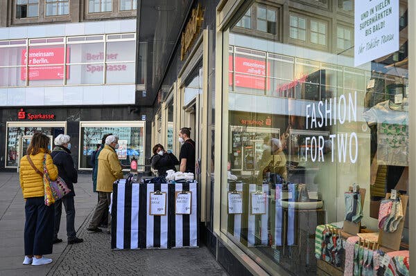 Shoppers in Berlin’s Alexanderplatz. Germany and other countries have cut their value-added taxes to encourage consumer spending.