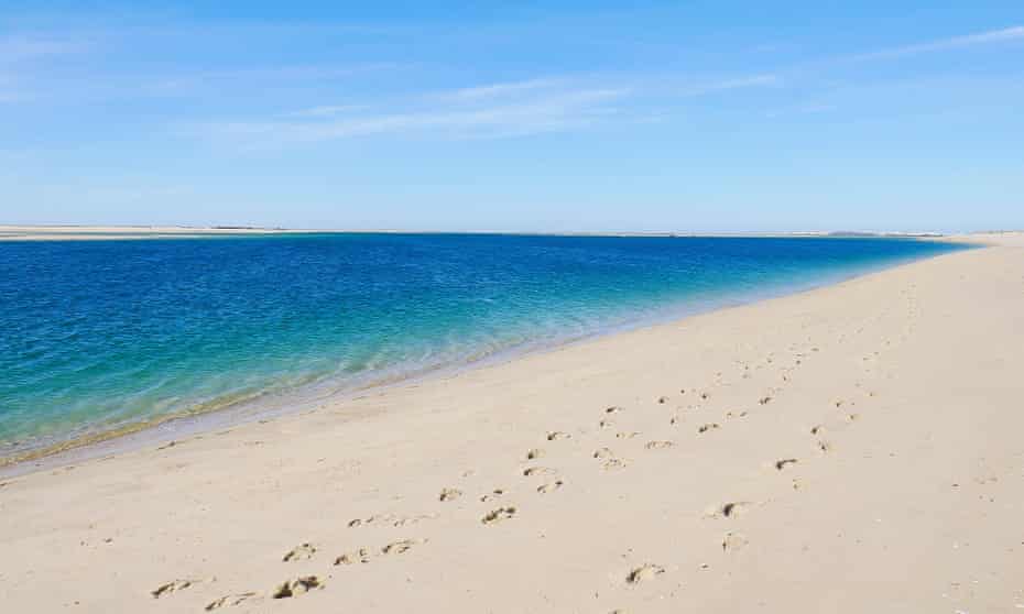 An empty Armona beach, lapped by a tranquil sea.