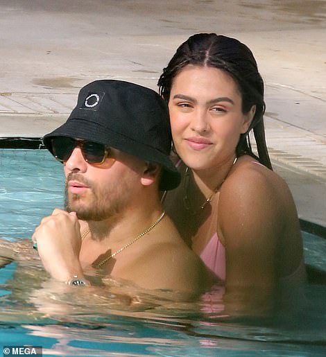 No hiding it: The pair put on a very affectionate display in the public pool as they cozied up to one another in the water