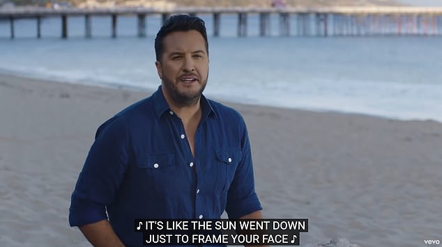 There he is: Bryan also stars in the new video as he sings from the beach