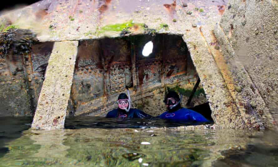 Snorkellers exploring the WW1 ship the SS Reginald in Scapa Flow, the Orkney Islands.