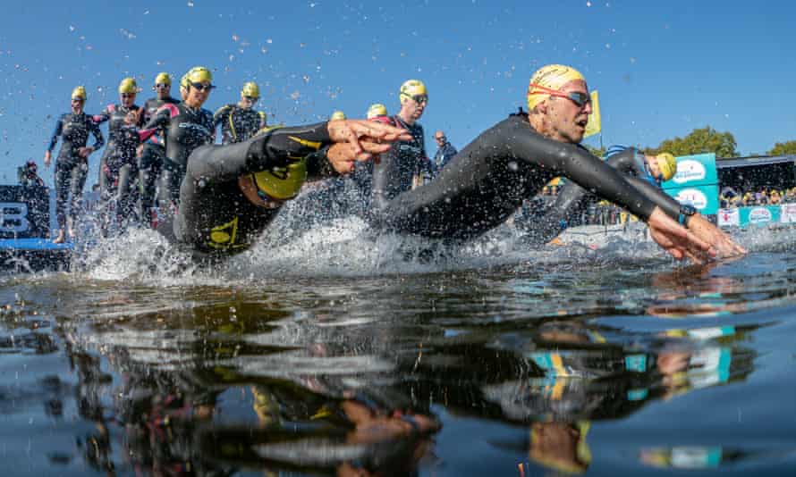 Group of swimmers at an organised event, on a sunny day, in the Serpentine, London, UK.