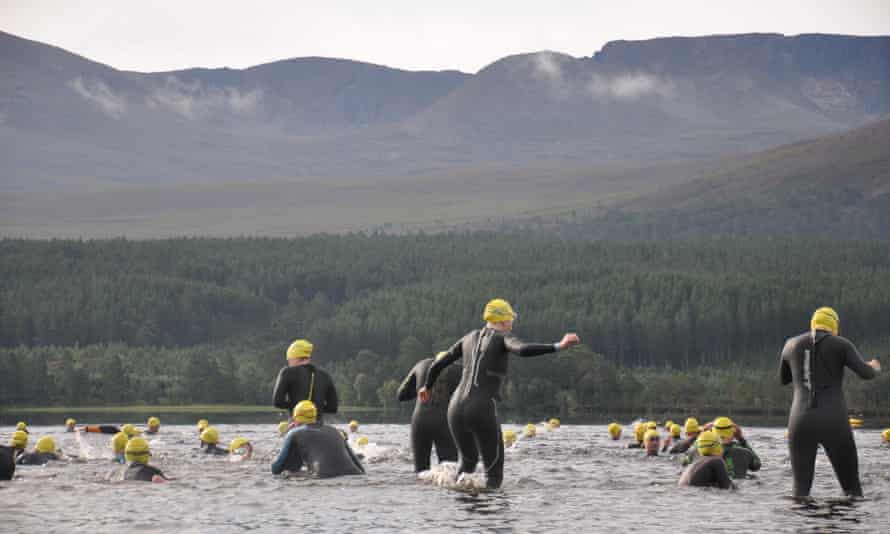 Swimmers in Loch Morlich, Scotland, UK.