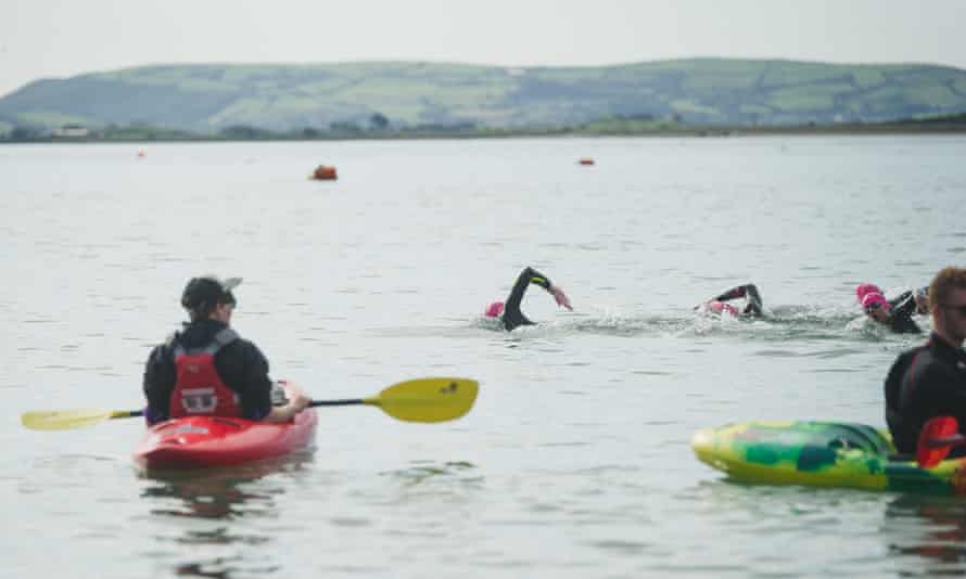 Swimmers in water near Aberdovey, Wales, UK.