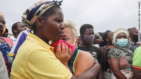 A woman cries as she waits for her son to arrive in Pemba on April 1, 2021, from the boat of evacuees from Palma. 