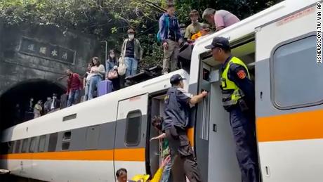 Passengers are helped to climb out of the train in Hualien County, Taiwan, on April 2.