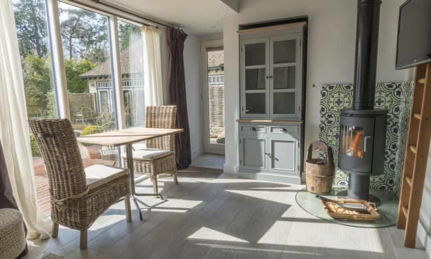 A table and two chairs in a pretty, light-flooded room