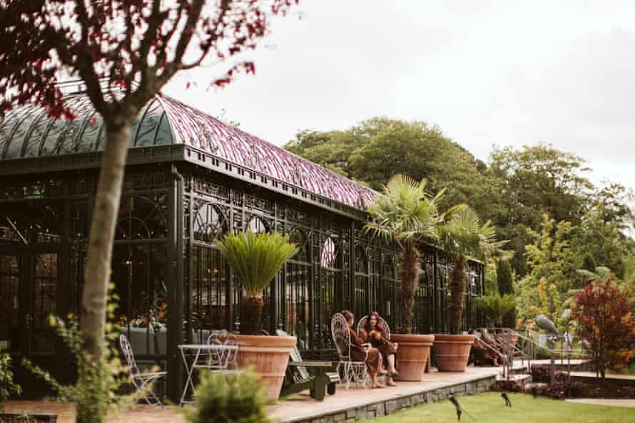 Two guests sat outside the Palm House, Galgorm Spa and Golf Resort, Ballymena, Northern Ireland, UK.