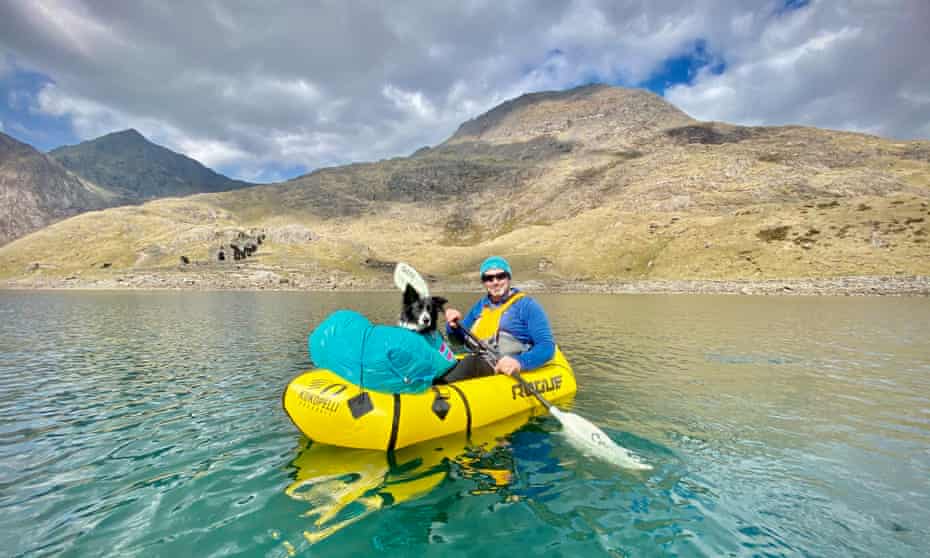 Jason Taylor packrafting with Crib Goch and Snowdon in the background.