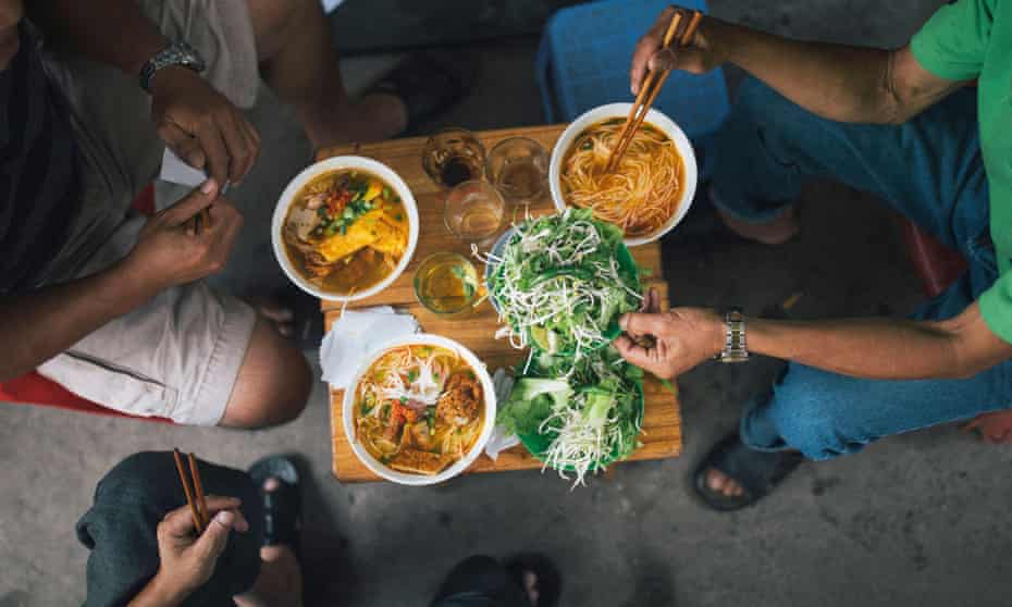 Tucking into bowls of bún bò Huế in Vietnam.