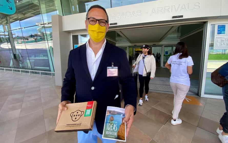 João Fernandes, head of the Algarve tourism, welcomes visitors at Faro airport on Monday.